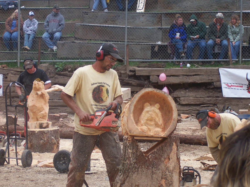 A person carving Lumber jack using chainsaw
