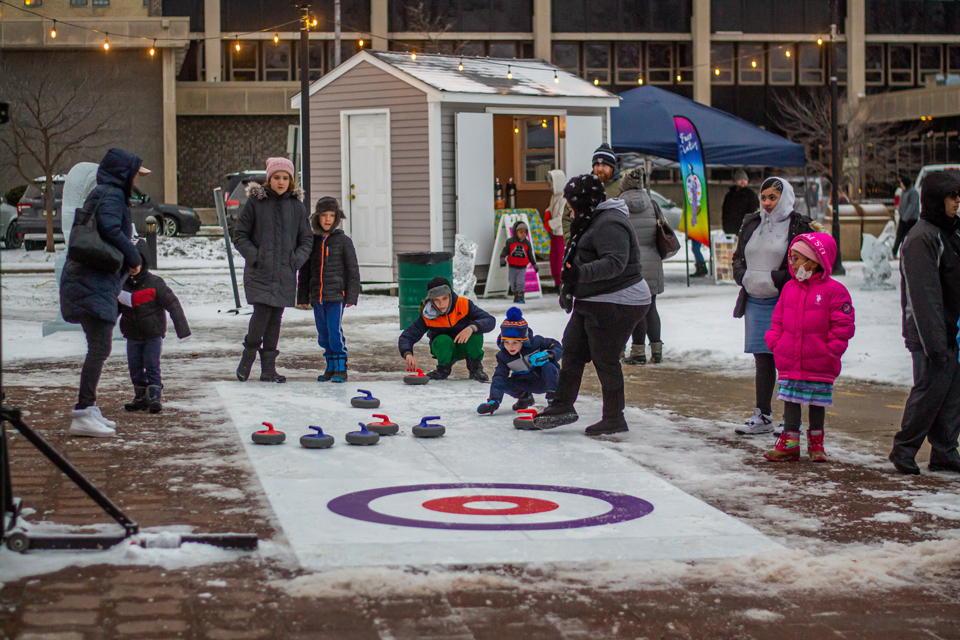 kids and adults playing ice curls