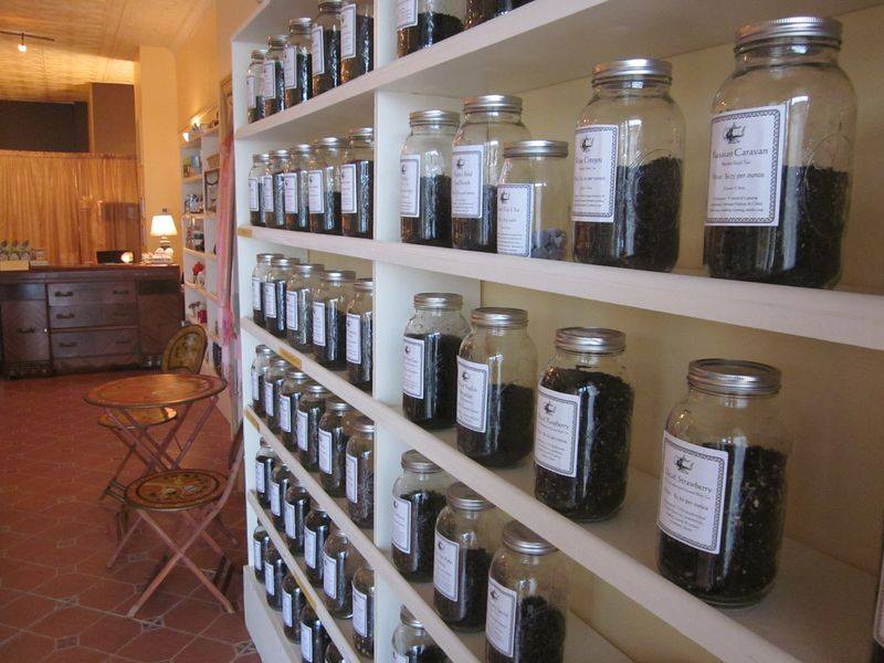 glass jars filled with tea leaves assorted in shelves
