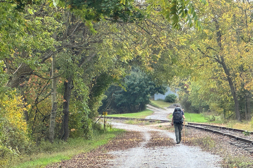 a person trekking thru Rail Trail