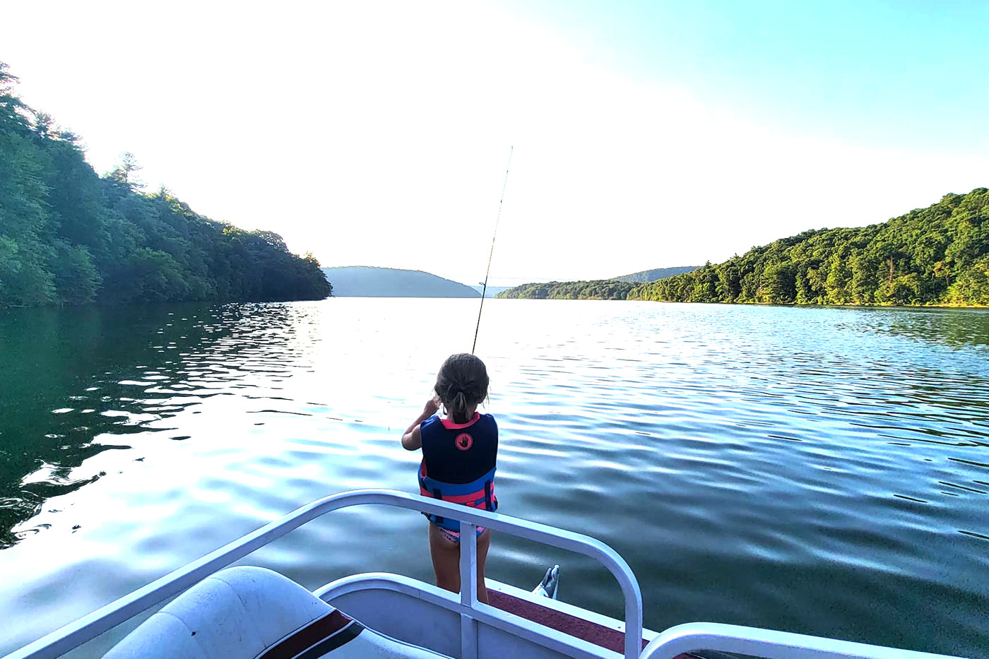 little girl fishing from a boat on Raystown lake