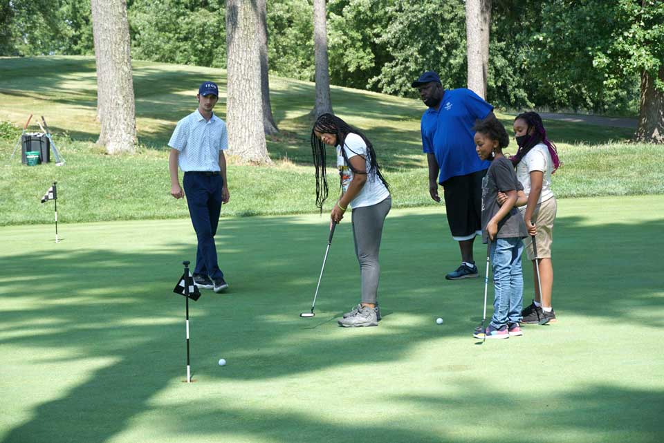 A Family Playing Golf at the Course