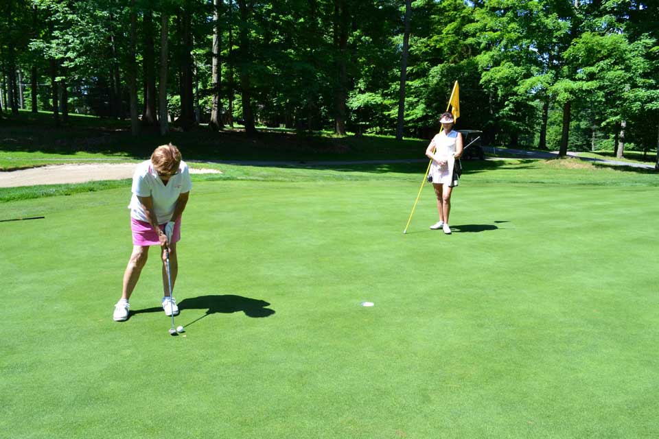 two ladies playing golf