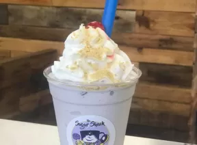 smoothie glass topped with Whipp Cream and a cherry on top